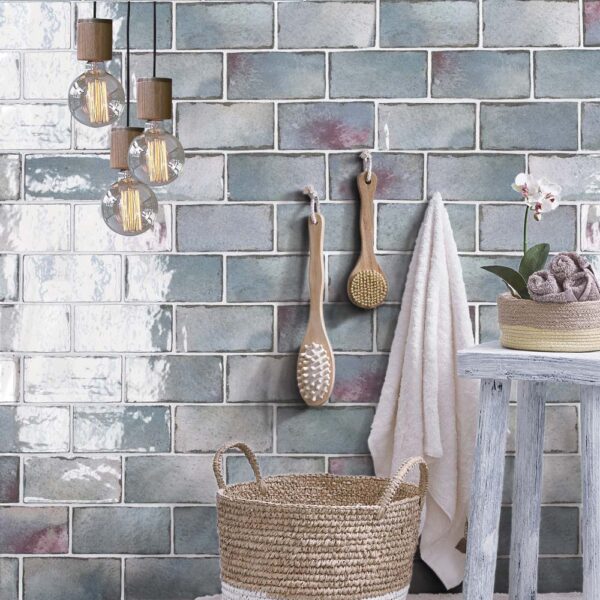 A bathroom with a basket and some towels hanging on the wall