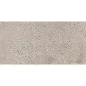 A gray tile floor with white grout and a small area of cement.