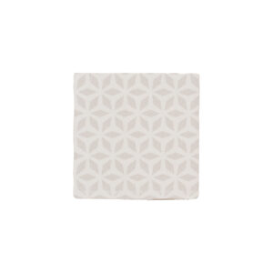 A white tile with a pattern of circles.