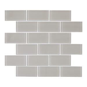 A white brick wall with some gray tiles