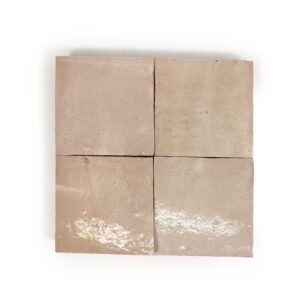 A square of four beige tiles on top of a white surface.
