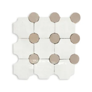A white tile with brown dots on it