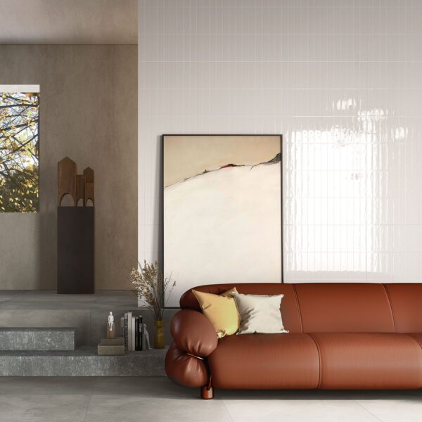 A brown leather couch in front of a wall.