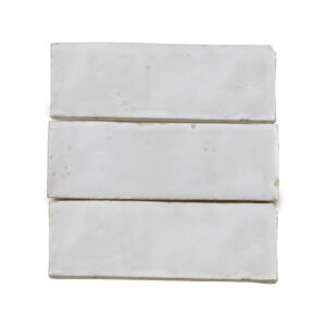 A white tile with three pieces of it
